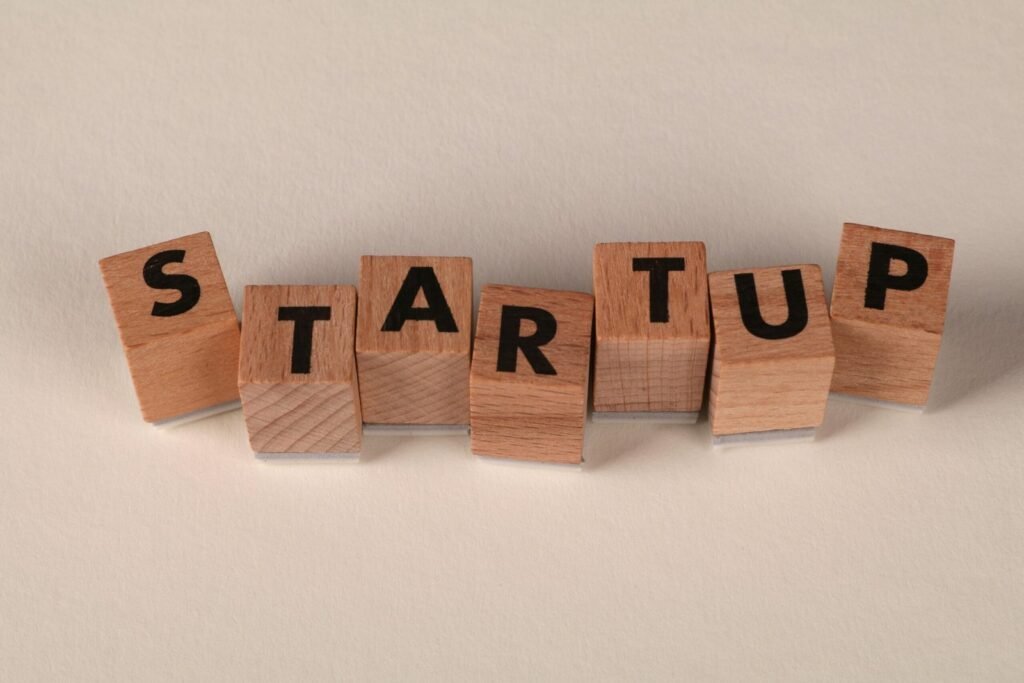 Wooden blocks forming the word 'STARTUP' on a neutral background, symbolizing new business ventures.